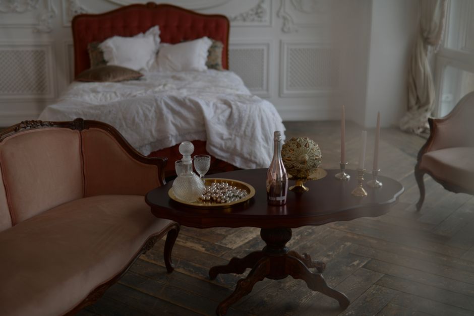 Luxurious vintage bedroom with ornate furniture and soft lighting creates a serene ambiance.