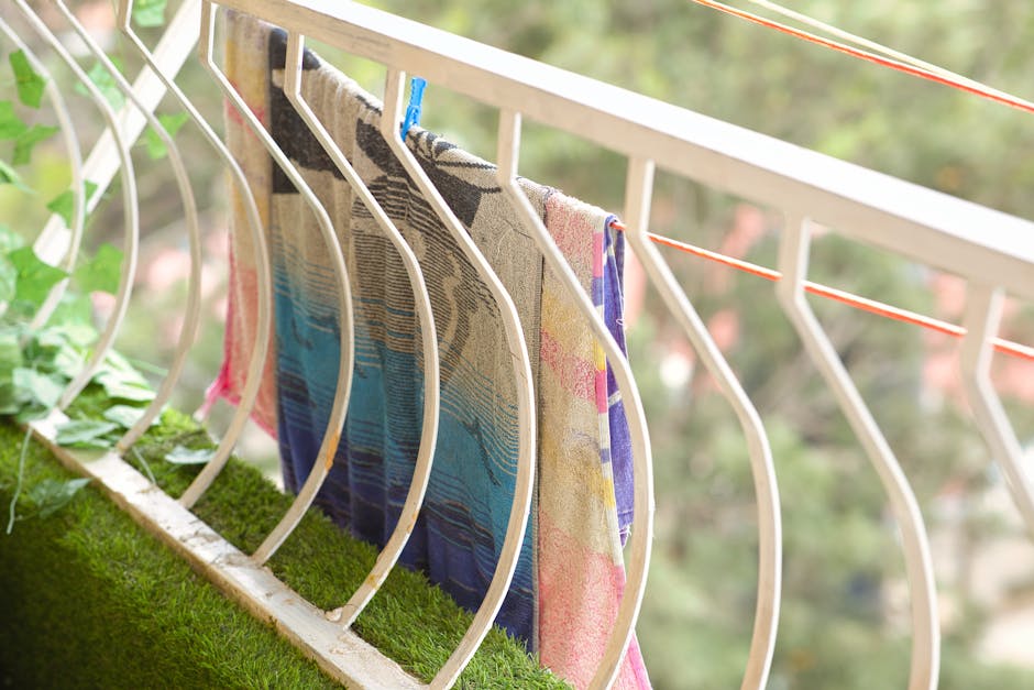 Vivid towels hanging on a balcony railing to dry in the outdoor breeze in Kenya.