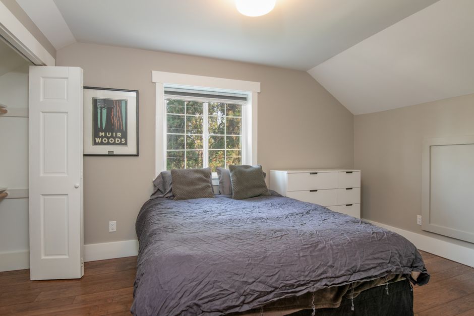 Cozy minimalist bedroom with natural light, neutral colors, and modern decor.