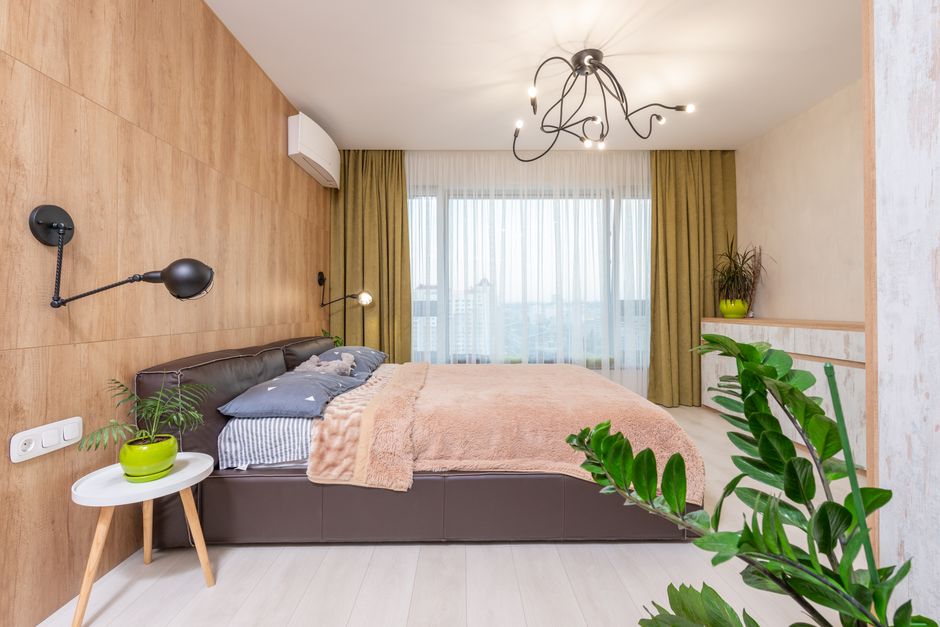 A stylish bedroom with wood accents, a plush bed, and modern decor.